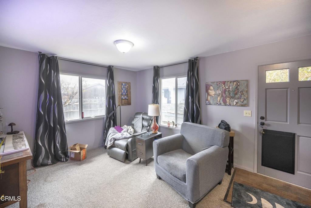 375 South Corry Street Fort Bragg, CA 95437 - Photo 23 of 34 a living room with furniture gym equipment and a large window