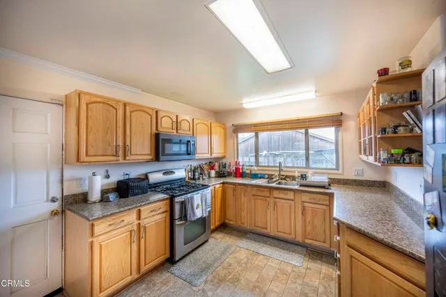 a kitchen with lots of counter top space and sink