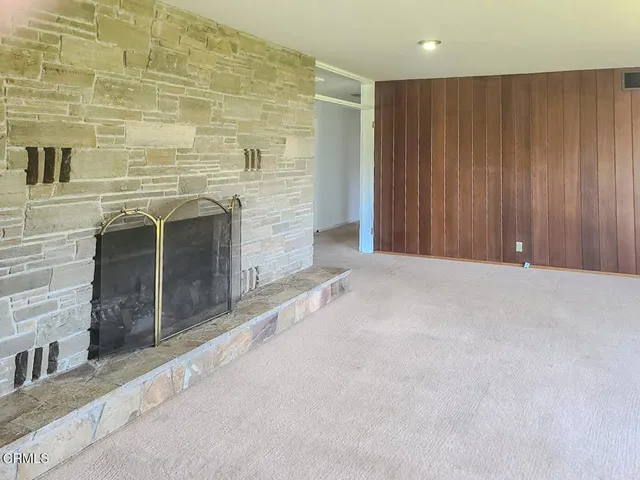 a view of an empty room with a fireplace