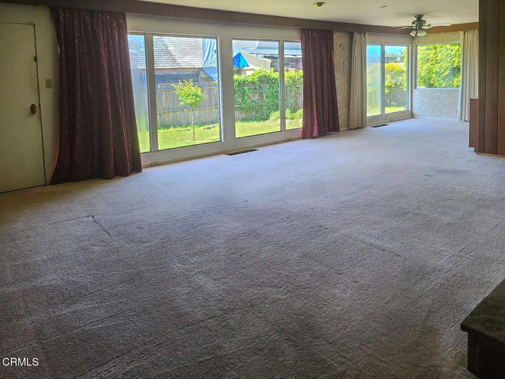 375 South Corry Street Fort Bragg, CA 95437 - Photo 9 of 34 a view of an empty room with large windows and a backyard