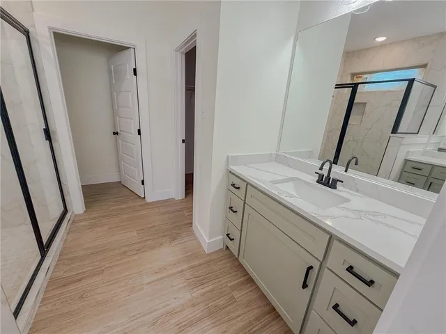 a bathroom with a sink a mirror and a shower