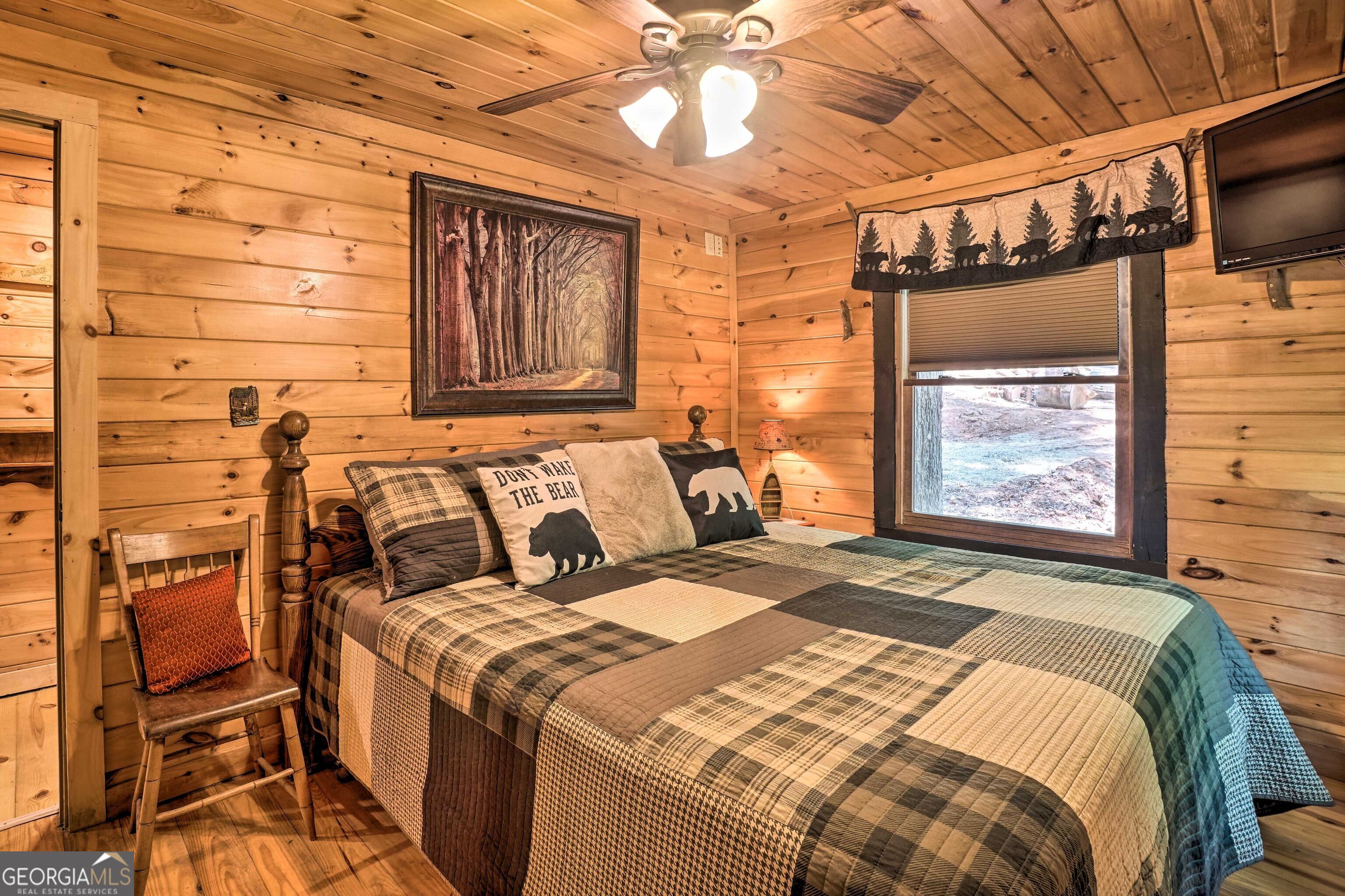 2183 Chimney Mountain Road Sautee Nacoochee, GA 30571 - Photo 16 of 28 a bed sitting in a bedroom next to a window