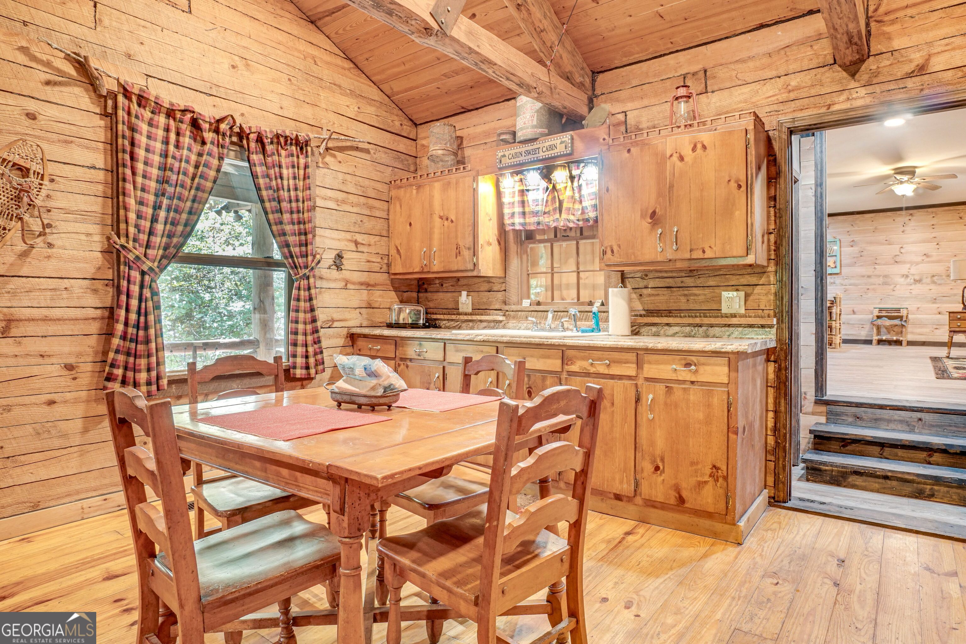 2183 Chimney Mountain Road Sautee Nacoochee, GA 30571 - Photo 9 of 28 a dining room with stainless steel appliances a table and chairs next to a window