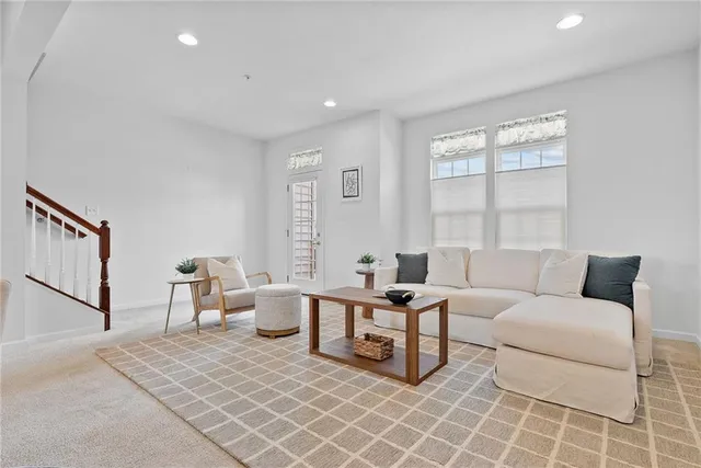 a living room with furniture a window and a table