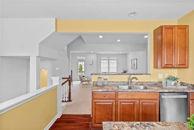a spacious bathroom with a granite countertop sink and a large mirror