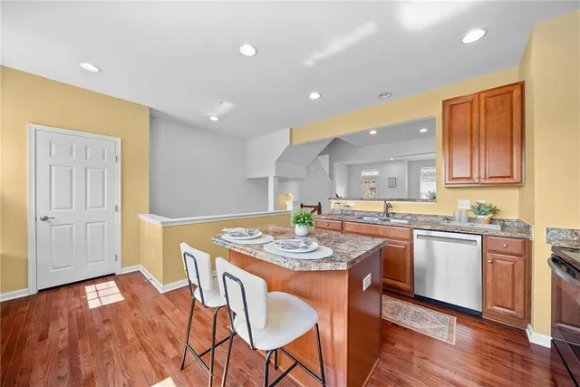 a large kitchen with a table and chairs in it