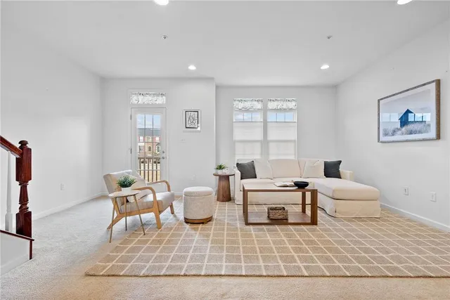 a living room with furniture a table and a large window