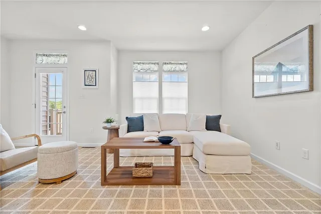 a living room with furniture a table and window