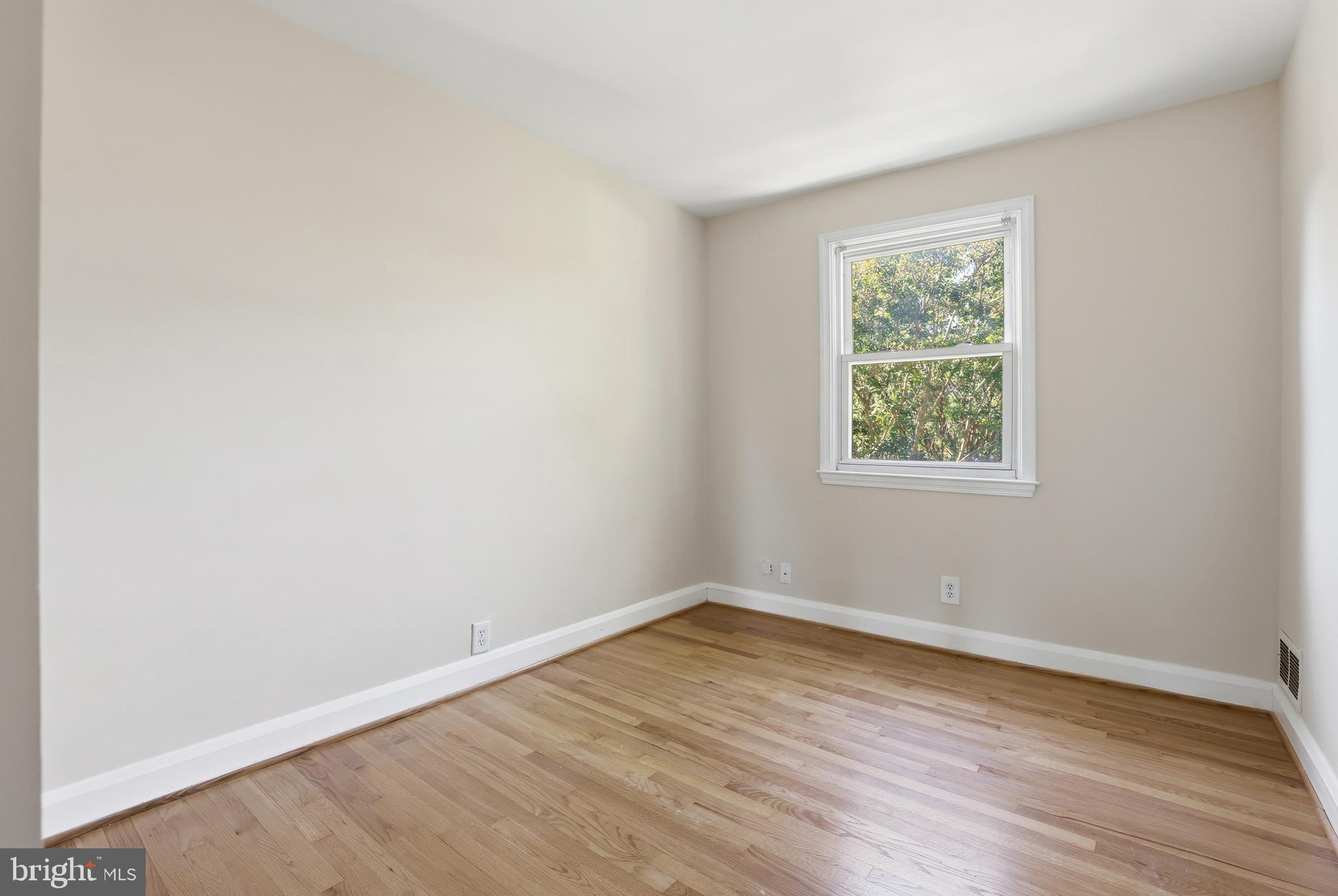 1002 Winsford Road Baltimore, MD 21204 - Photo 13 of 30 an empty room with wooden floor and windows