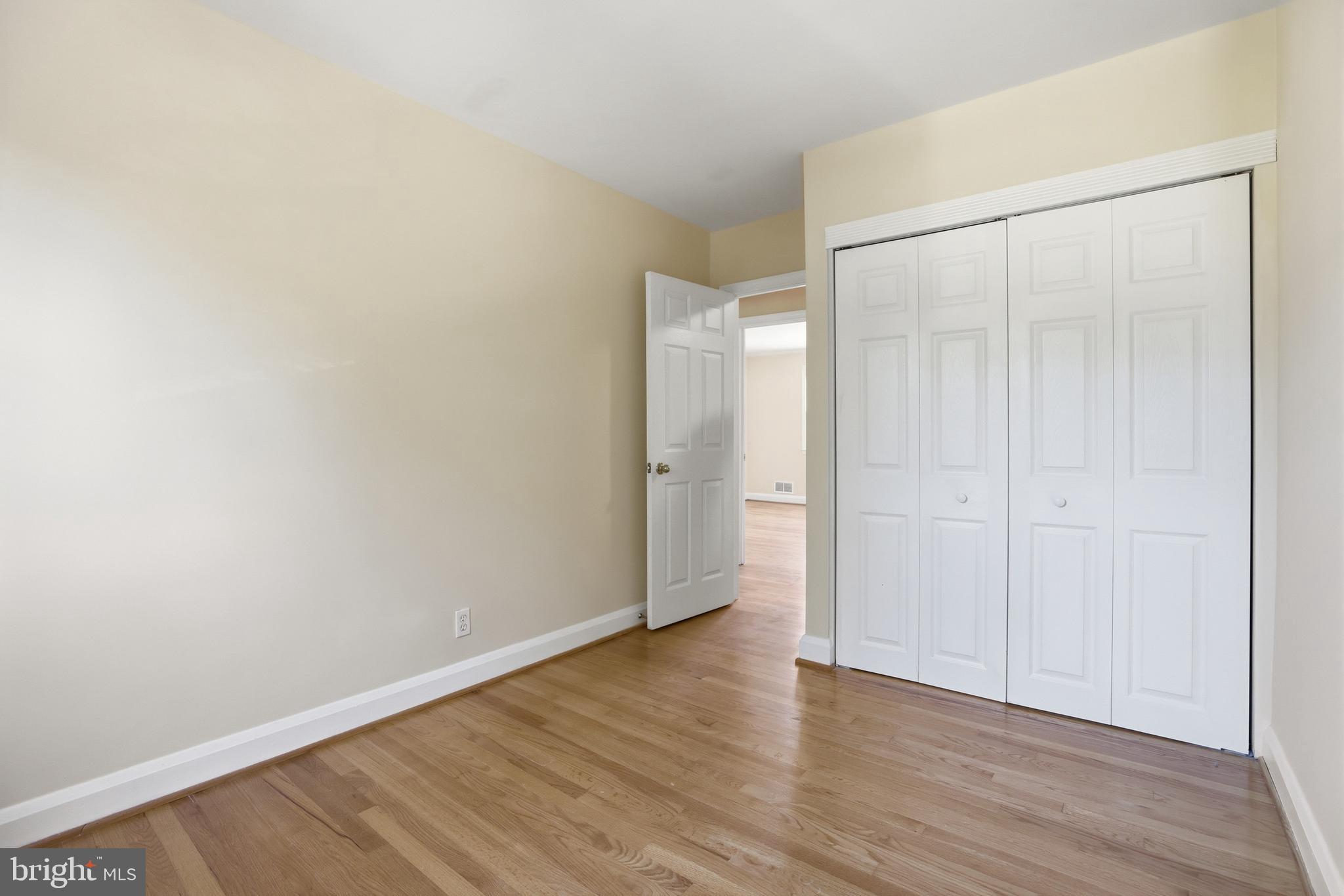 1002 Winsford Road Baltimore, MD 21204 - Photo 14 of 30 a view of an empty room with wooden floor and a window