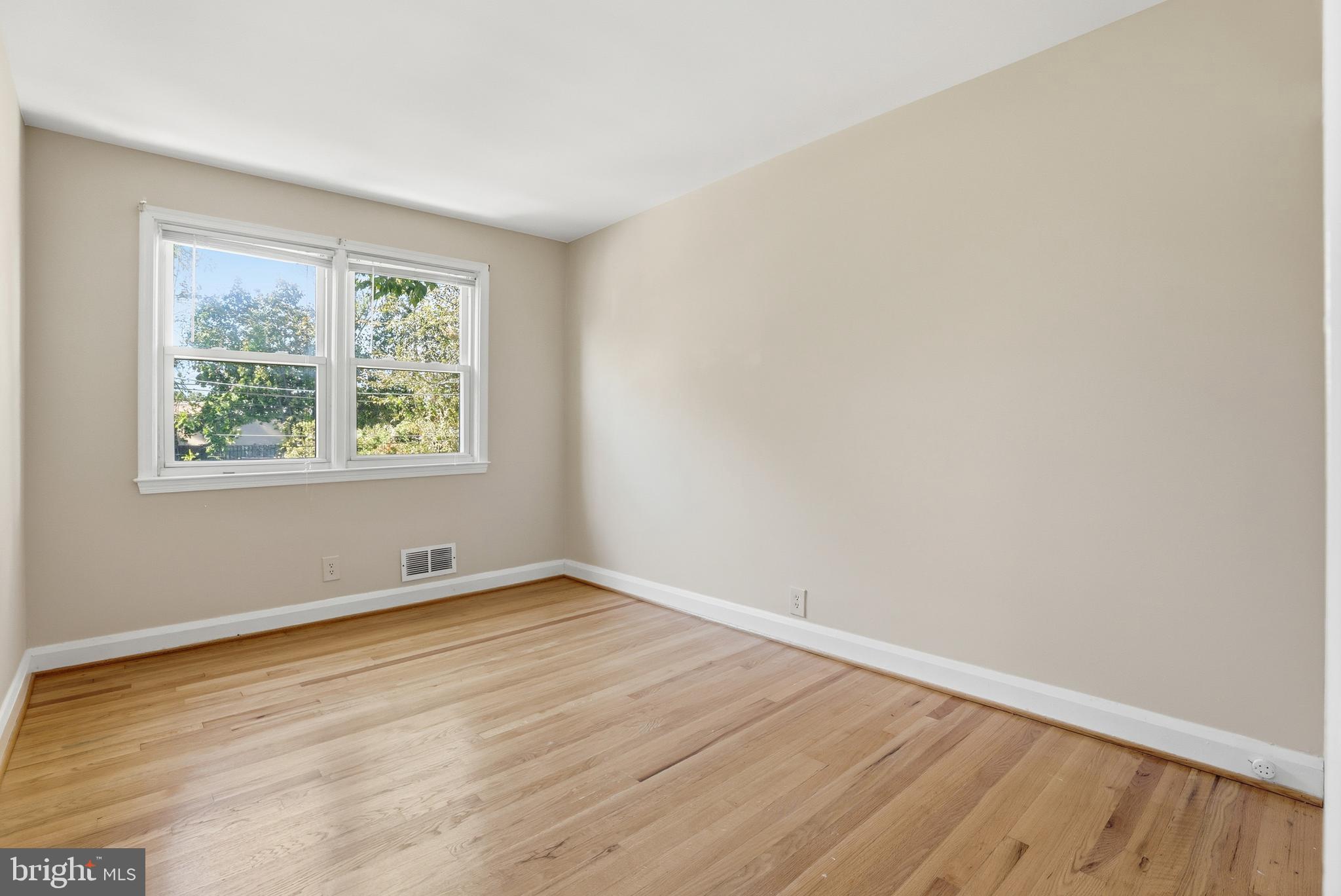 1002 Winsford Road Baltimore, MD 21204 - Photo 15 of 30 an empty room with wooden floor and windows