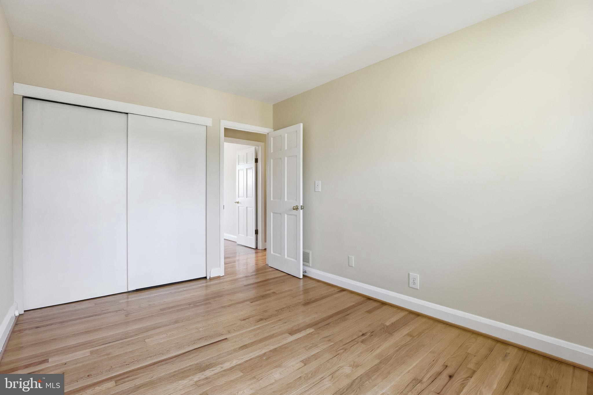 1002 Winsford Road Baltimore, MD 21204 - Photo 16 of 30 a view of an empty room with wooden floor