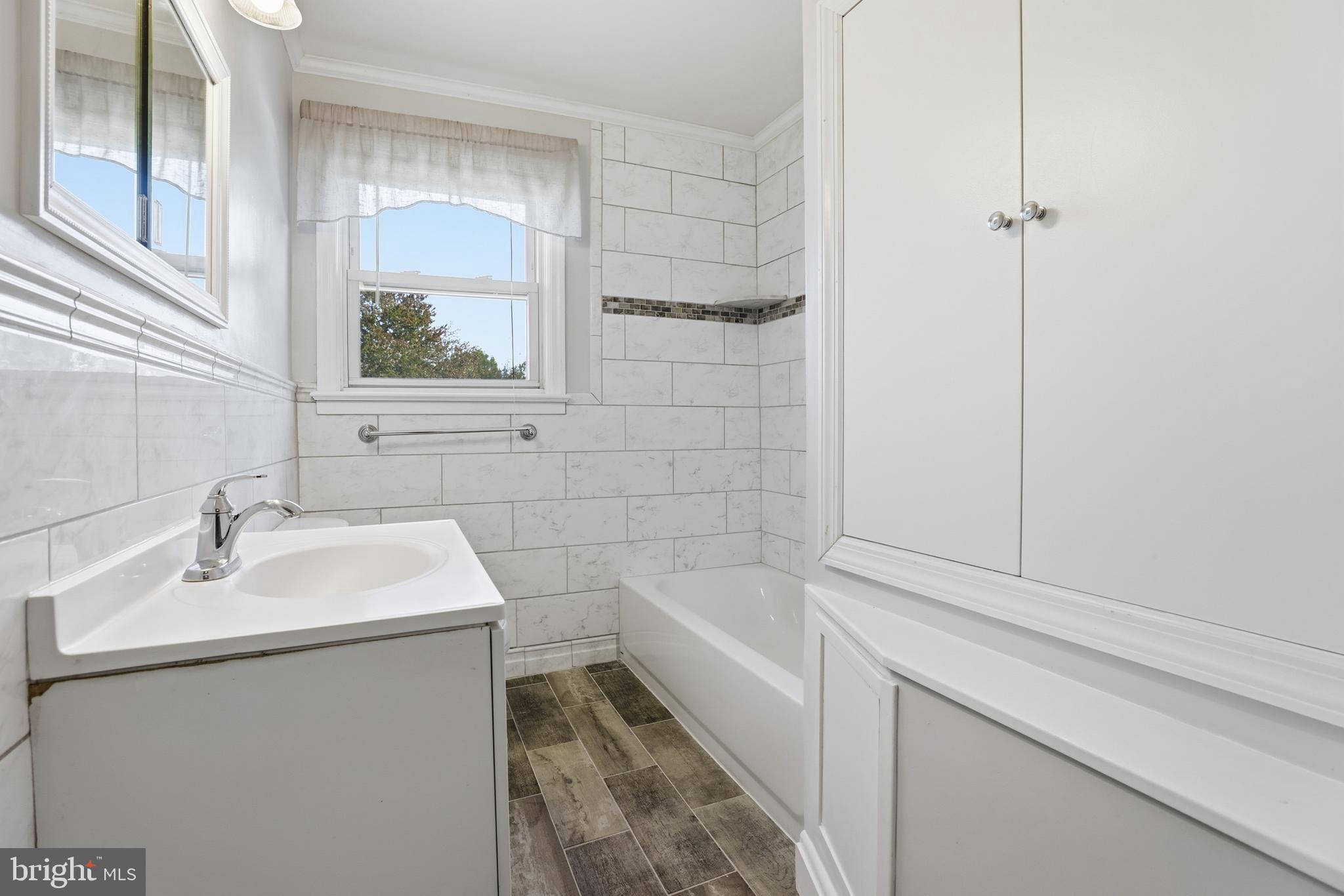 1002 Winsford Road Baltimore, MD 21204 - Photo 19 of 30 a bathroom with a sink and mirror