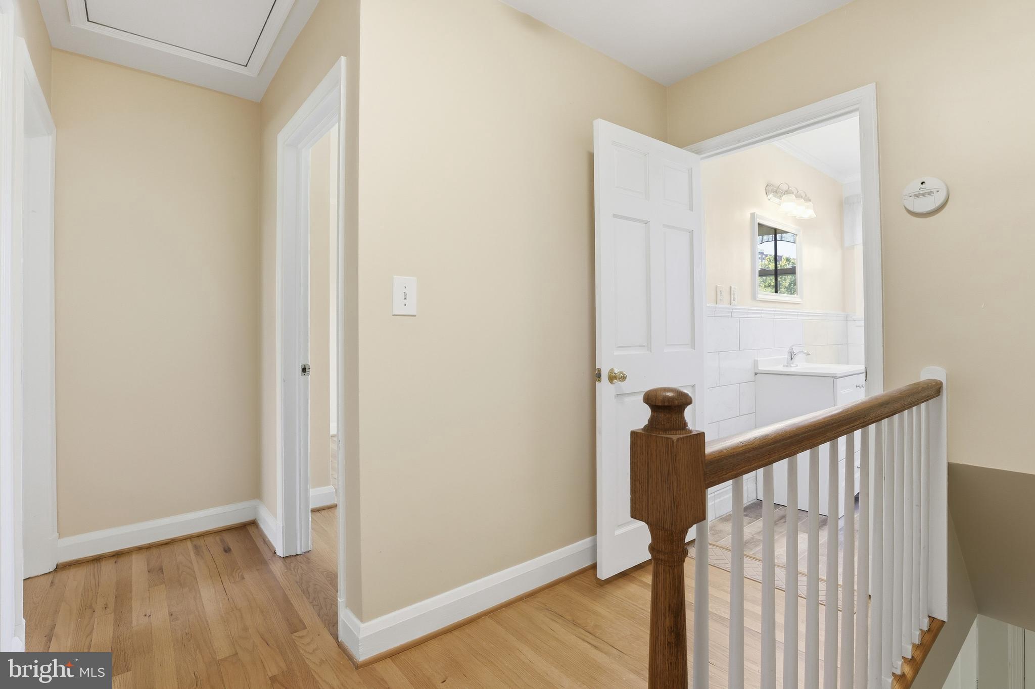 1002 Winsford Road Baltimore, MD 21204 - Photo 20 of 30 a view of a hallway with wooden floor and staircase