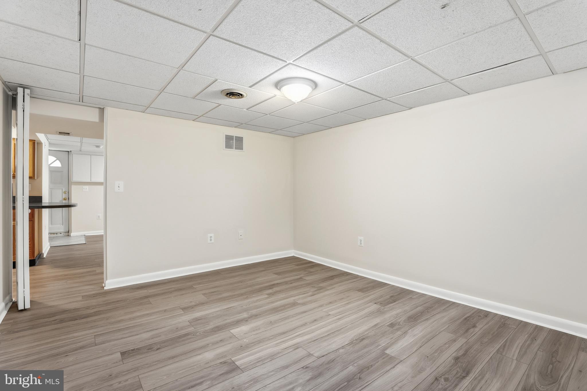 1002 Winsford Road Baltimore, MD 21204 - Photo 21 of 30 a view of an empty room with wooden floor