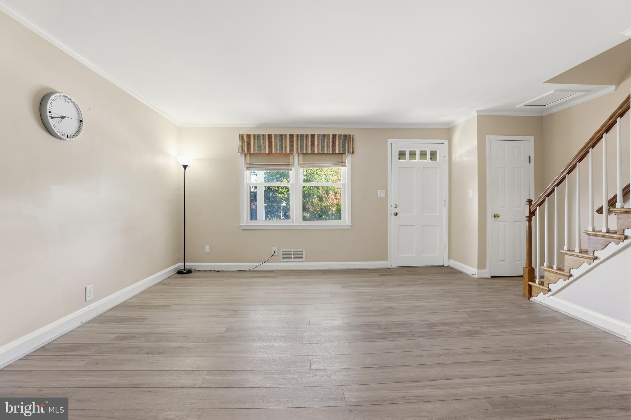1002 Winsford Road Baltimore, MD 21204 - Photo 7 of 30 a view of an empty room with wooden floor and a window