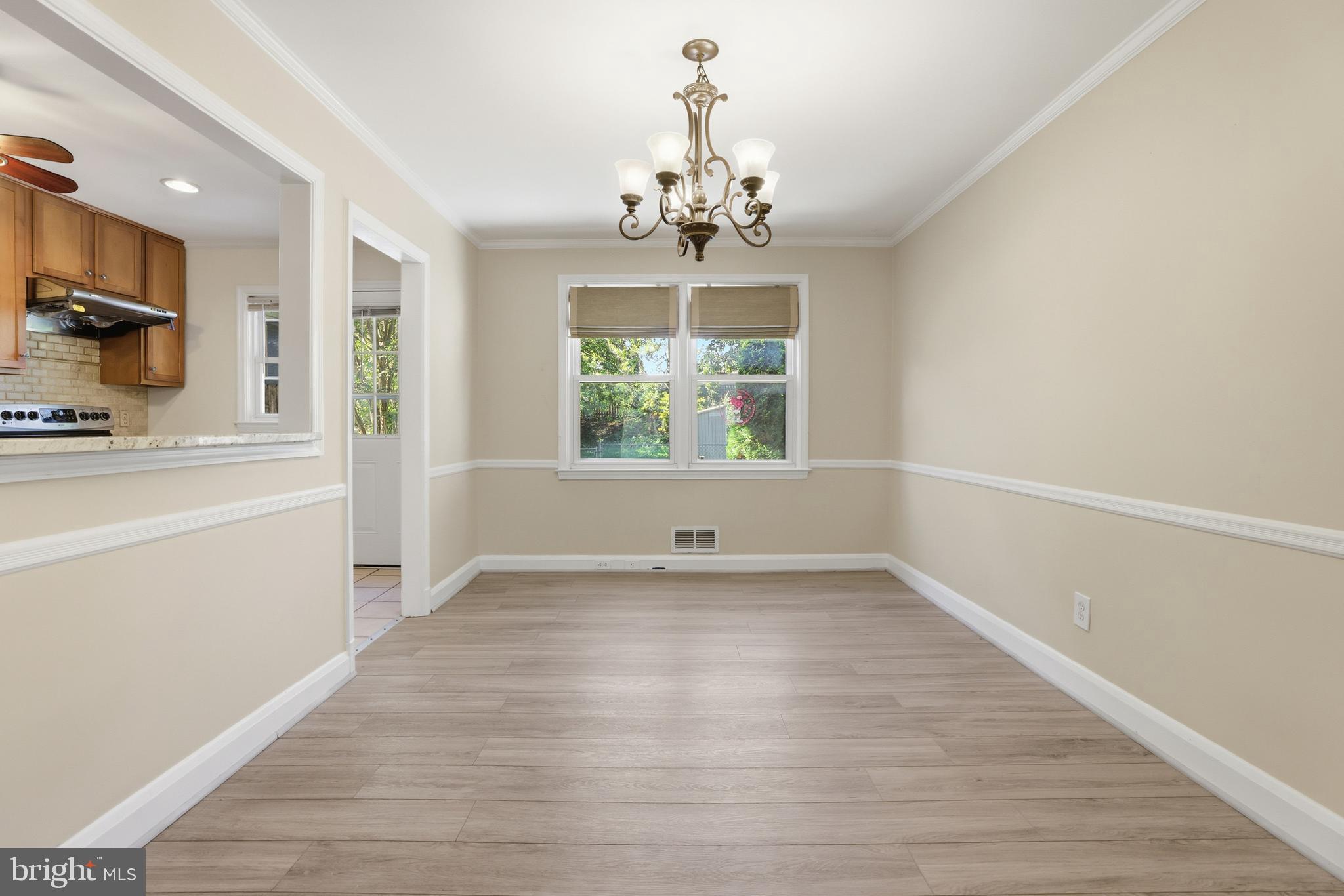 1002 Winsford Road Baltimore, MD 21204 - Photo 9 of 30 a view of an empty room with a window and wooden floor