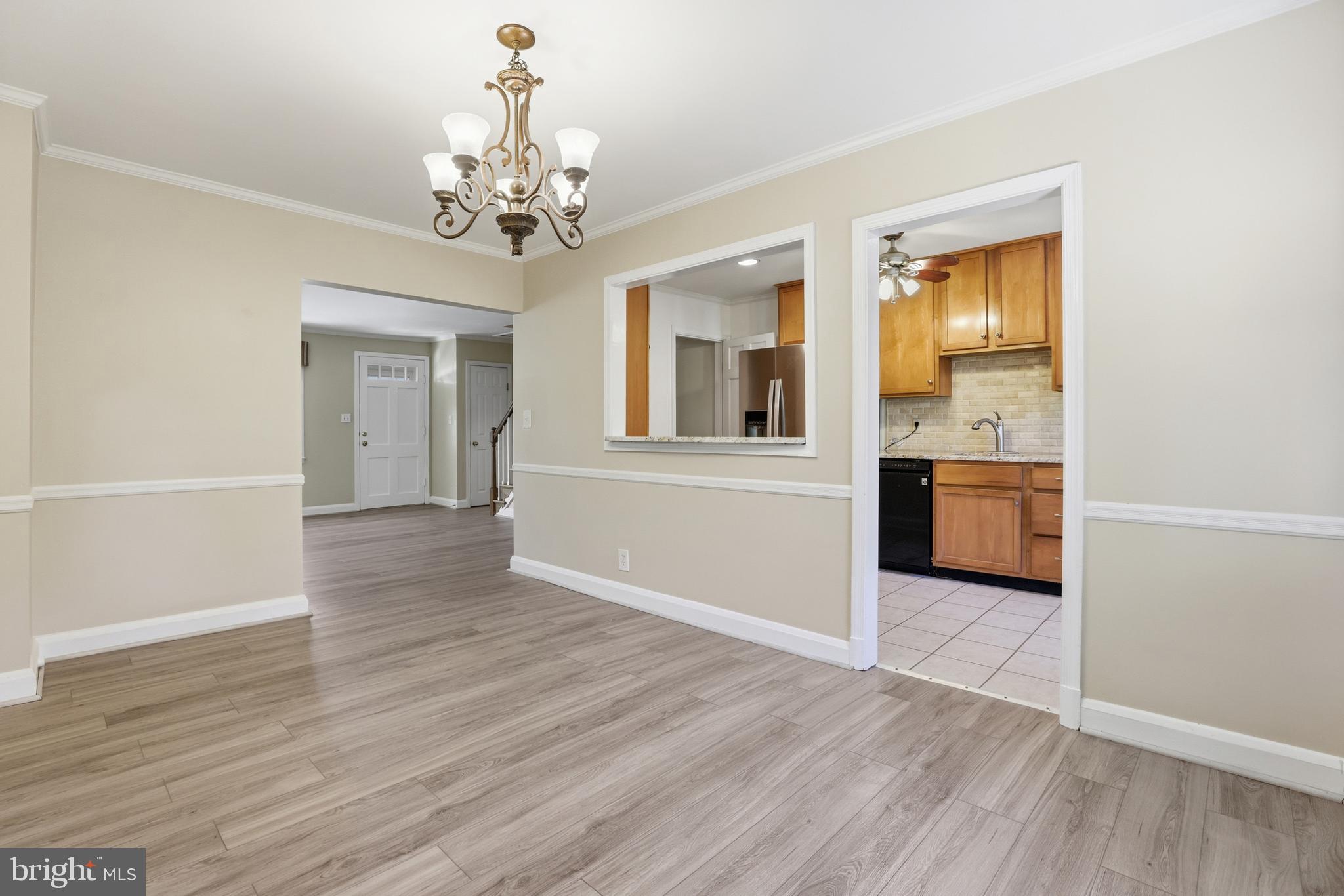 1002 Winsford Road Baltimore, MD 21204 - Photo 10 of 30 a view of an empty room with a window and wooden floor
