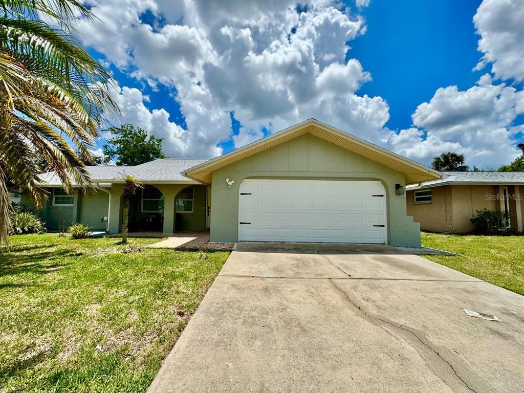 4282 Rudder Way New Port Richey, FL 34652 - Photo 1 of 34 a front view of a house with a yard and garage
