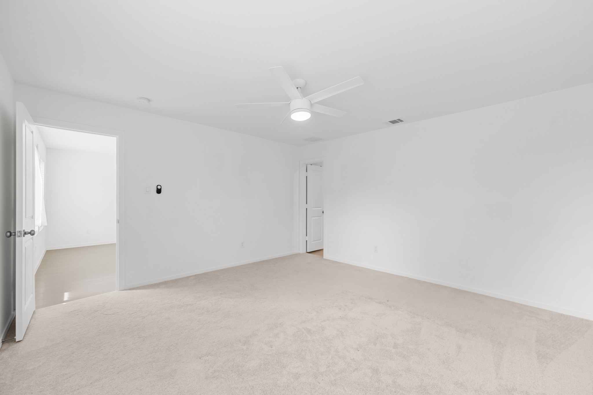 252 Houston Street Angleton, TX 77515 - Photo 23 of 49 Additional view of the primary bedroom showcases its generous proportions and direct connection to the adjoining spaces.