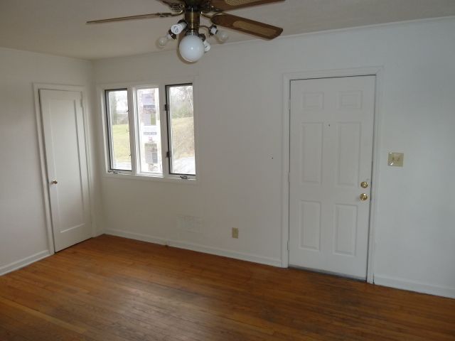 2203 Courtland Road Northeast Roanoke, VA 24012 - Photo 3 of 10 a view of an empty room with a window and wooden floor