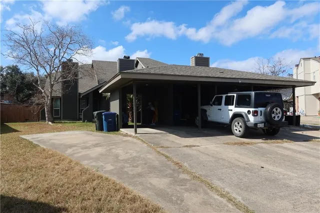 a view of a car parked in front of house