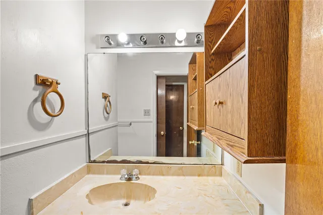 a bathroom with a sink and a mirror