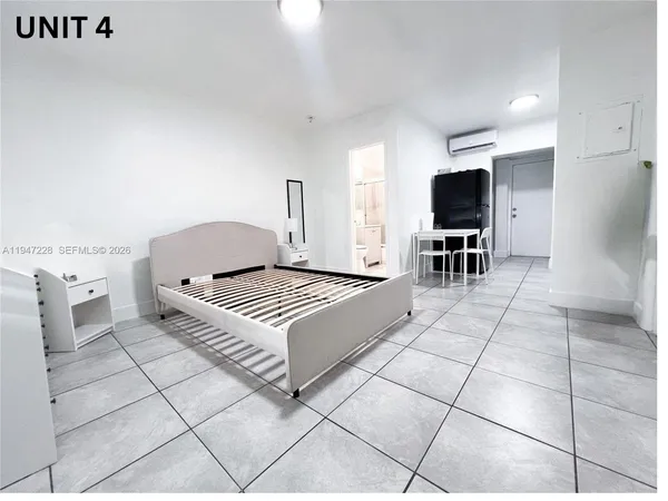 a bedroom with furniture and wooden floor
