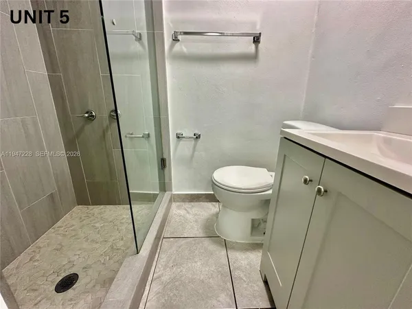 a bathroom with a shower and a sink
