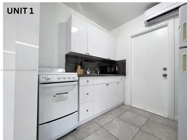 a kitchen with a stove and a microwave