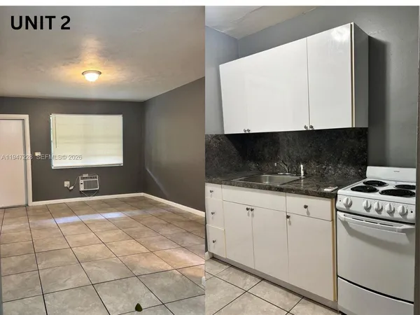 a kitchen with granite countertop a sink a stove and cabinets