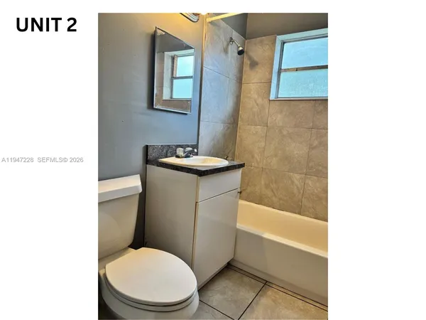 a bathroom with a toilet a sink and bathtub