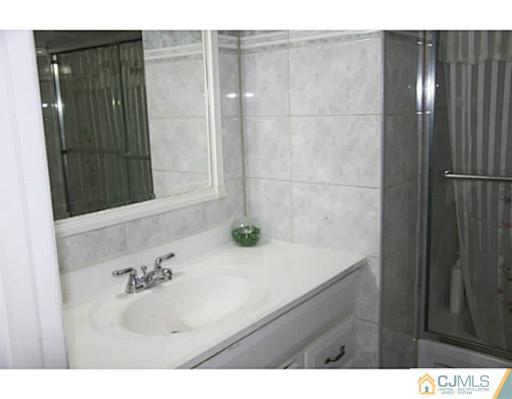 9 Halstead Road New Brunswick, NJ 08901 - Photo 12 of 24 a bathroom with a sink and a mirror