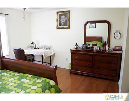 9 Halstead Road New Brunswick, NJ 08901 - Photo 17 of 24 a living room with furniture and a mirror