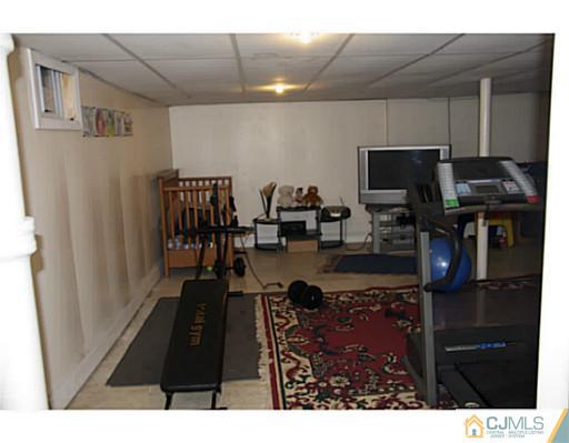 9 Halstead Road New Brunswick, NJ 08901 - Photo 24 of 24 a living room with furniture and a flat screen tv