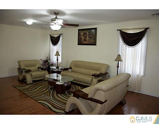 9 Halstead Road New Brunswick, NJ 08901 - Photo 3 of 24 a living room with furniture a chandelier and a window