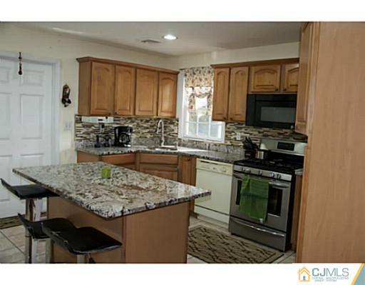 9 Halstead Road New Brunswick, NJ 08901 - Photo 9 of 24 a kitchen with a sink stove and microwave