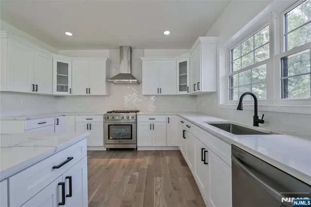 a kitchen with a sink stove and cabinets