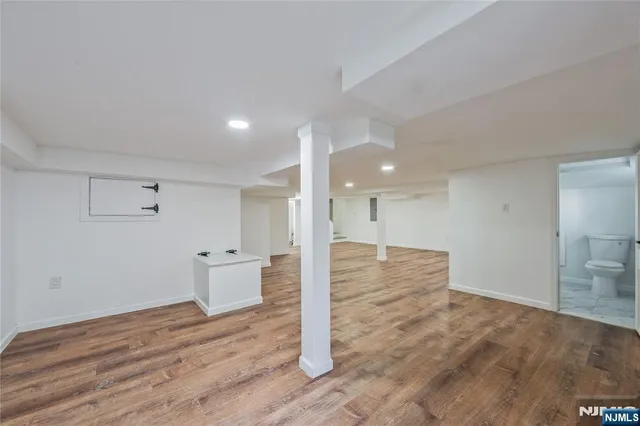 a view of a room with wooden floor and window
