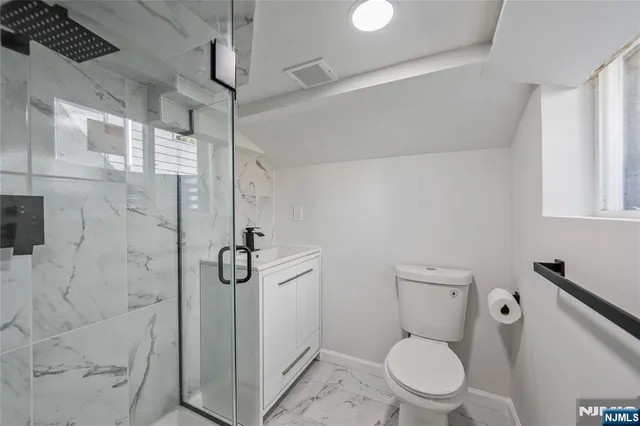 a bathroom with a toilet a sink and shower