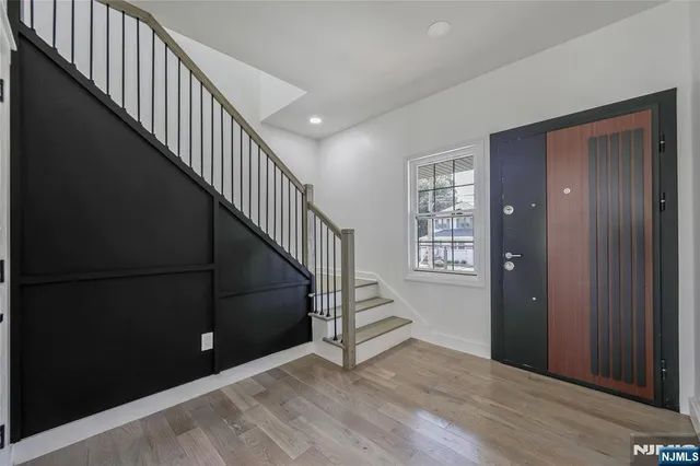 a view of entryway and hall with wooden floor