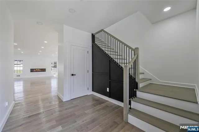 a view of entryway and hall with wooden floor