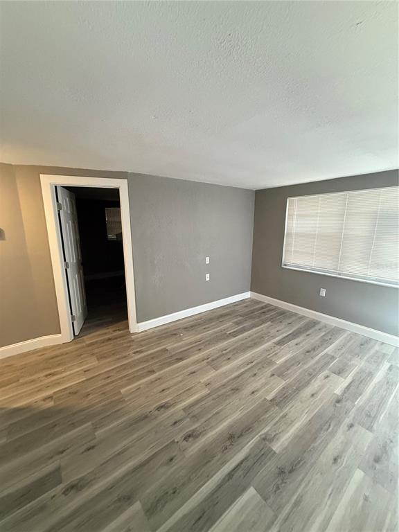 14830 Atlantic Avenue Hudson, FL 34667 - Photo 12 of 26 a view of empty room with wooden floor and fan