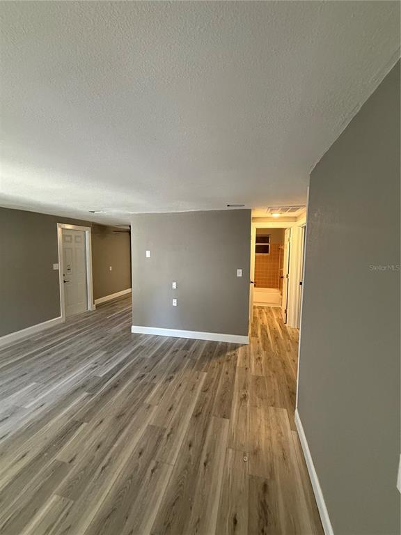 14830 Atlantic Avenue Hudson, FL 34667 - Photo 13 of 26 wooden floor in an empty room with a window