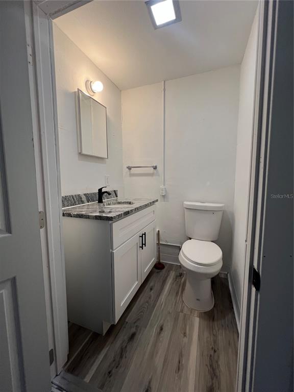14830 Atlantic Avenue Hudson, FL 34667 - Photo 18 of 26 a bathroom with a toilet a sink and mirror