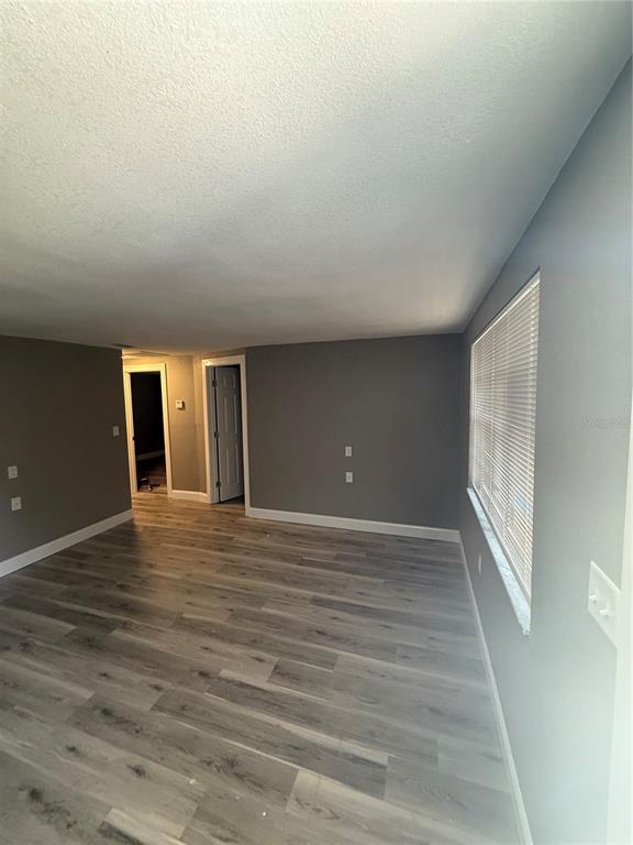 14830 Atlantic Avenue Hudson, FL 34667 - Photo 4 of 26 a view of an empty room with wooden floor and a window