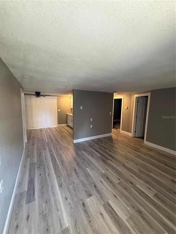 14830 Atlantic Avenue Hudson, FL 34667 - Photo 7 of 26 wooden floor in an empty room with a window