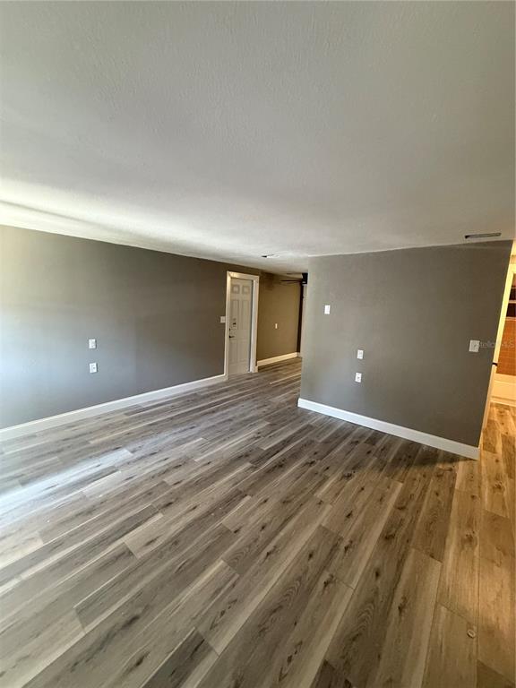 14830 Atlantic Avenue Hudson, FL 34667 - Photo 8 of 26 a view of empty room with wooden floor