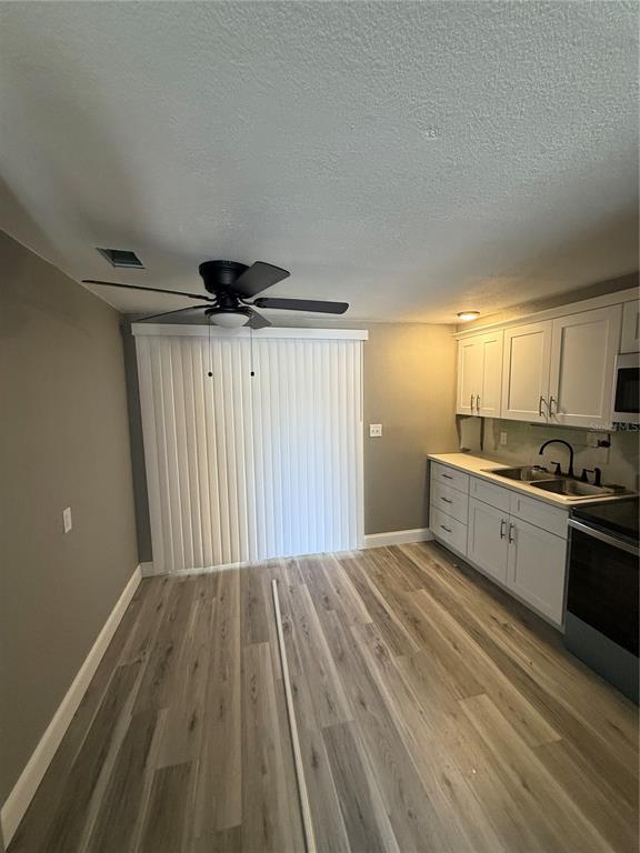 14830 Atlantic Avenue Hudson, FL 34667 - Photo 9 of 26 a kitchen with granite countertop a sink cabinets and stainless steel appliances