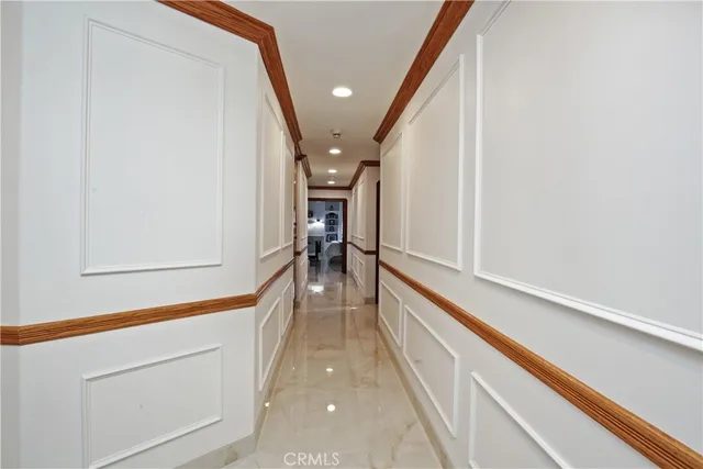 a hallway with a large window and furniture